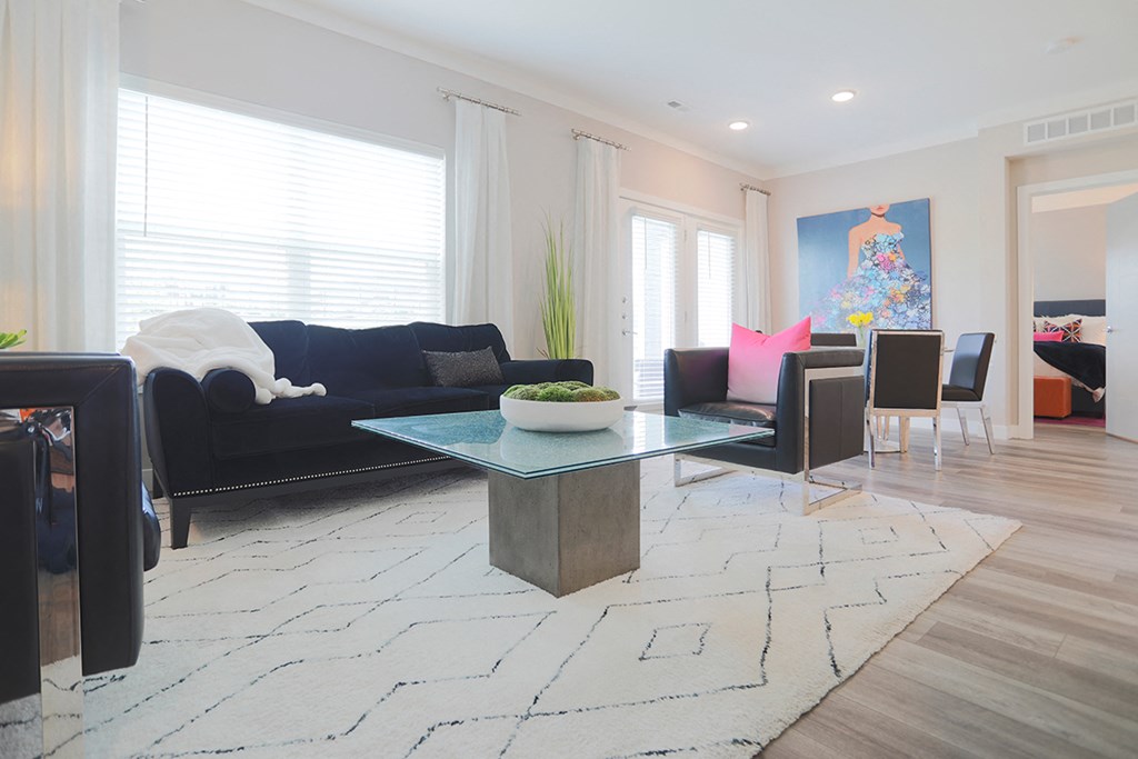 a living room with a blue couch and a table