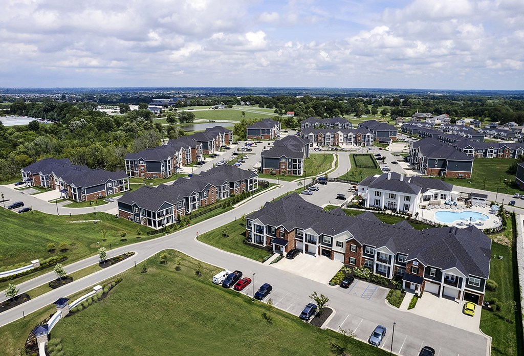 an aerial view of a neighborhood with houses and a swimming pool