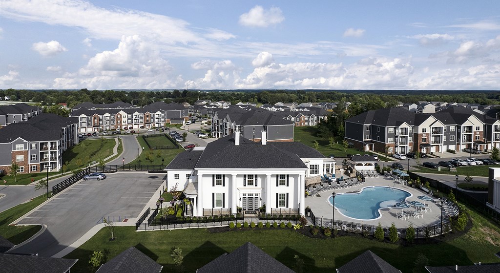 an aerial view of an apartment complex with a swimming pool