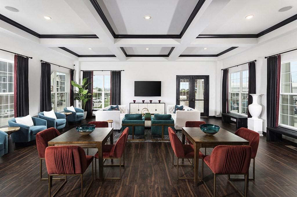 a large living room with a large table and chairs