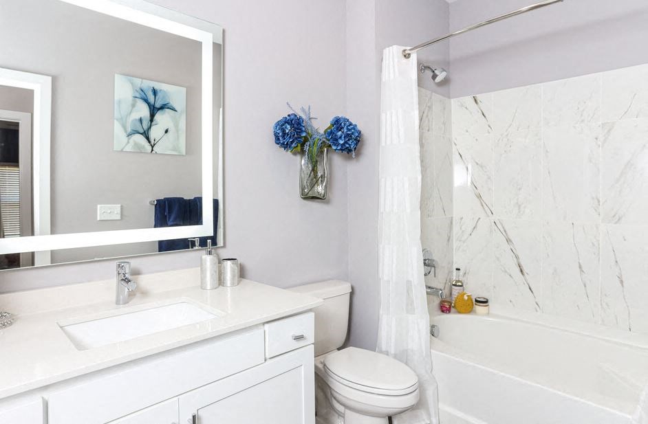 a bathroom with a sink toilet and a mirror