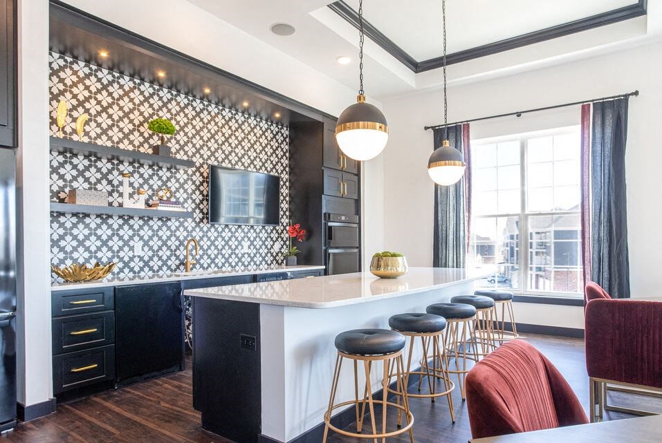 a kitchen with a white counter and bar stools