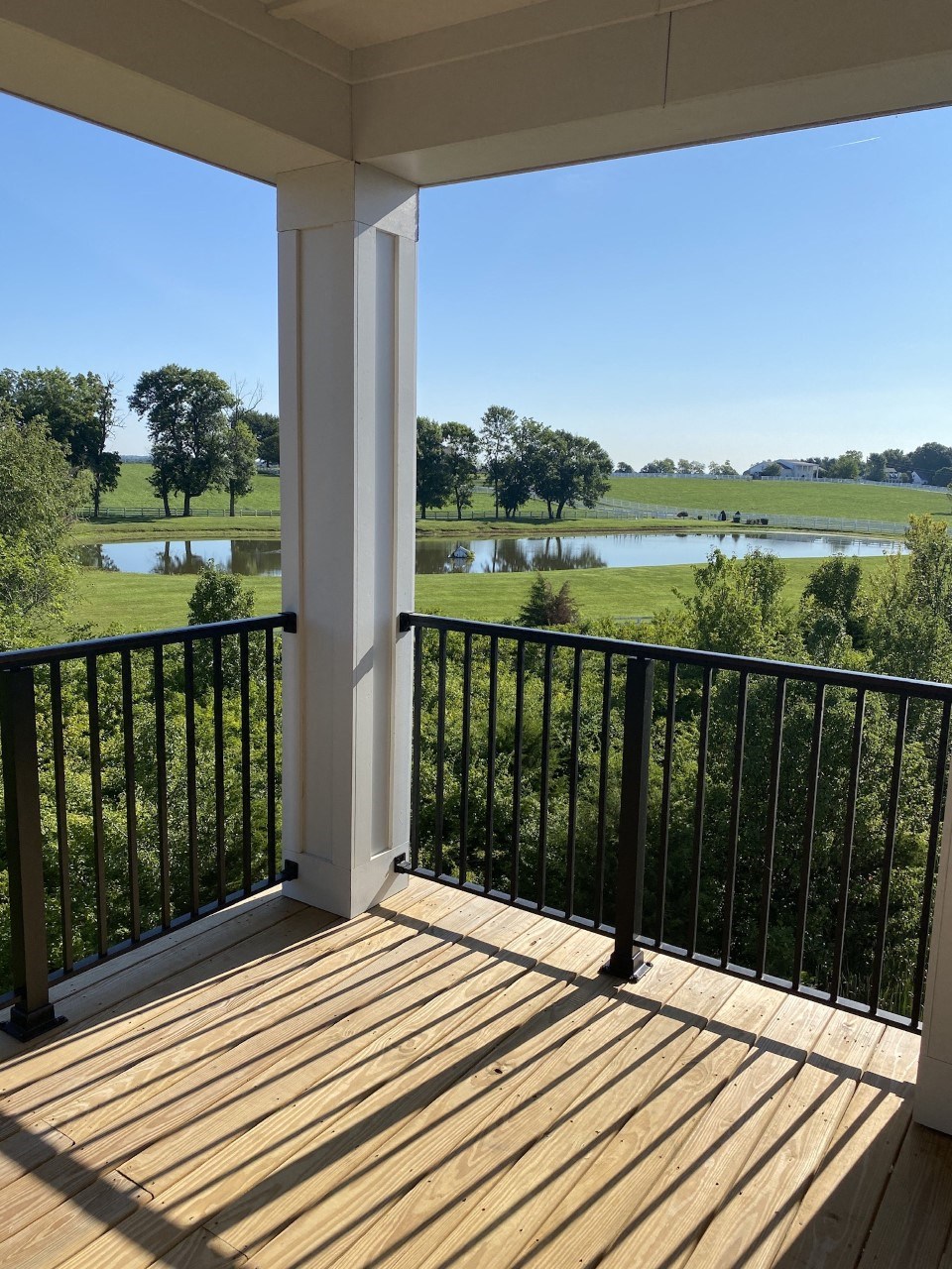 a view of a lake from a porch with a deck