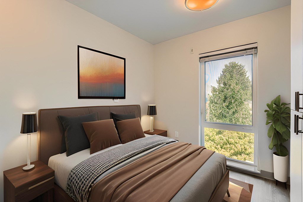 a bedroom with a bed and a large window