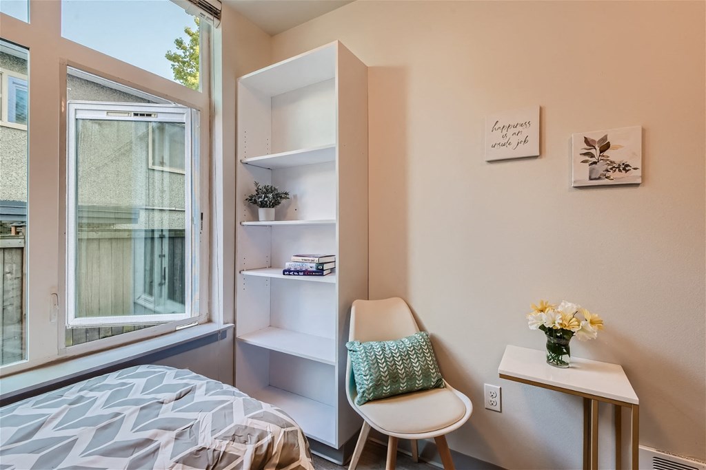 a small room with a bed and a window