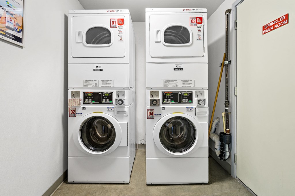two washers and two dryers in a laundry room