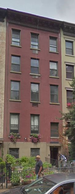 a man riding a bike in front of a building