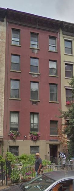 a man riding a bike in front of a building