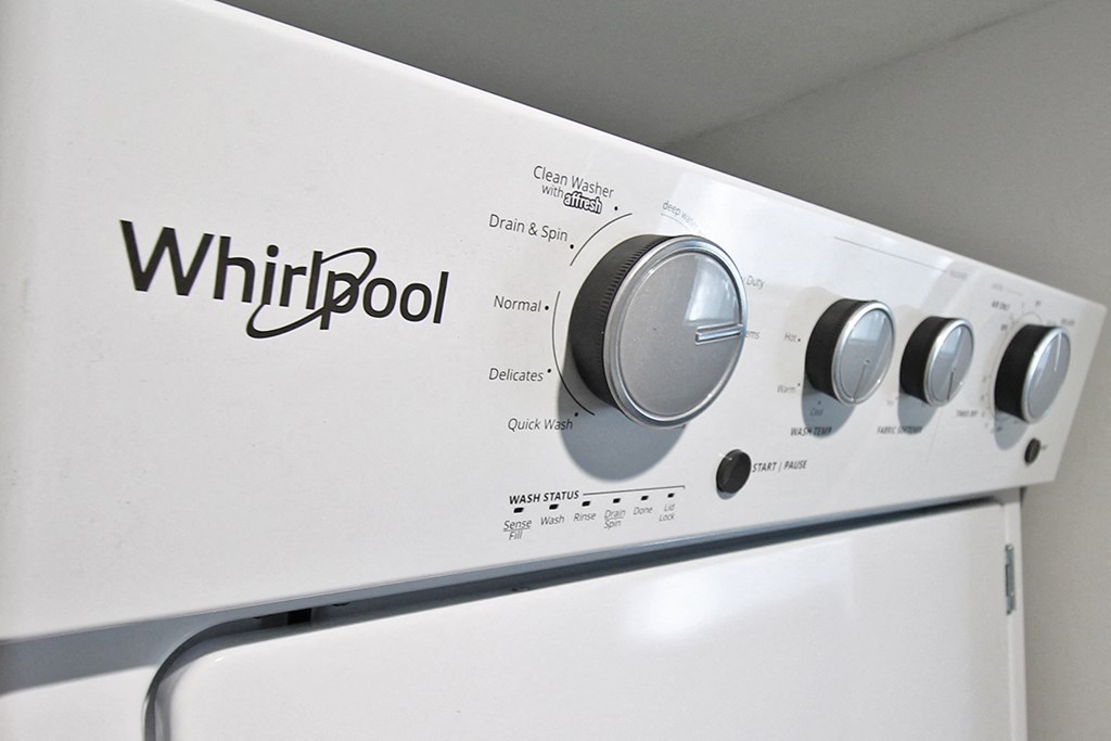 a whirlpool washer and dryer with a logo on the side of