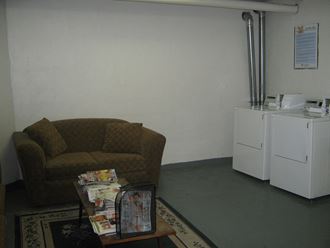 a living room with a couch and two refrigerators