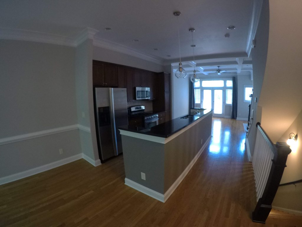 a kitchen and living room of an empty apartment