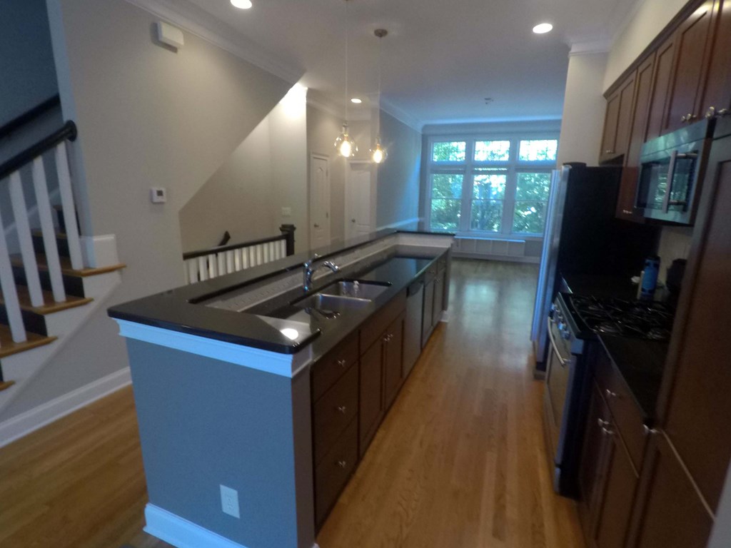 an empty kitchen with a large island in the middle