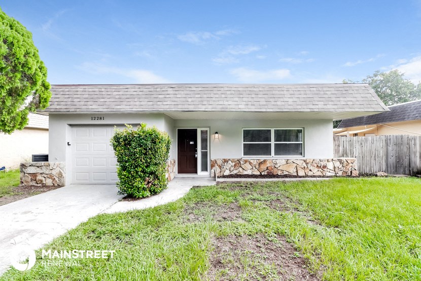 a white house with a yard and a white garage door