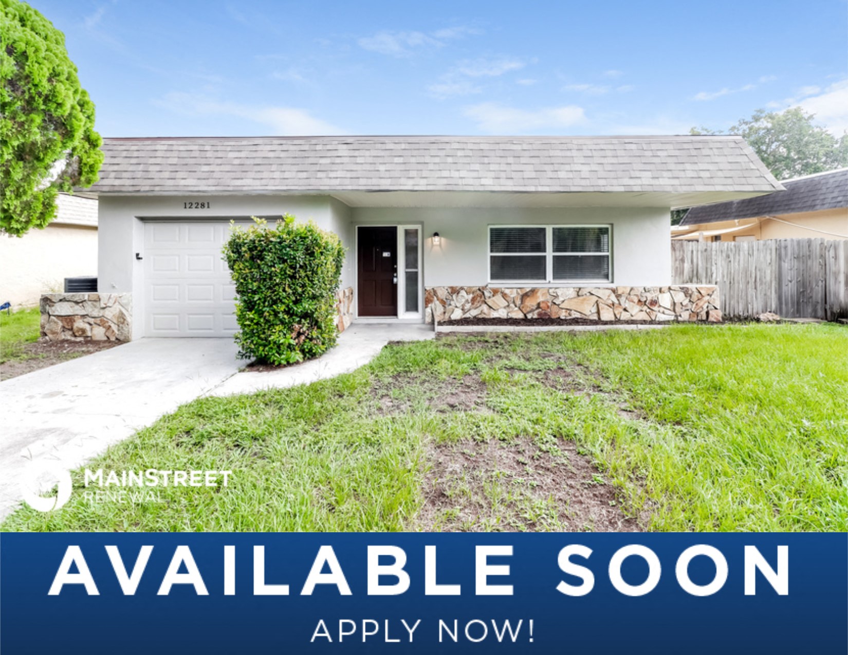 a small white house with a lawn and a driveway