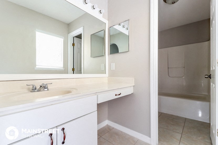 a bathroom with a sink and a mirror and a shower