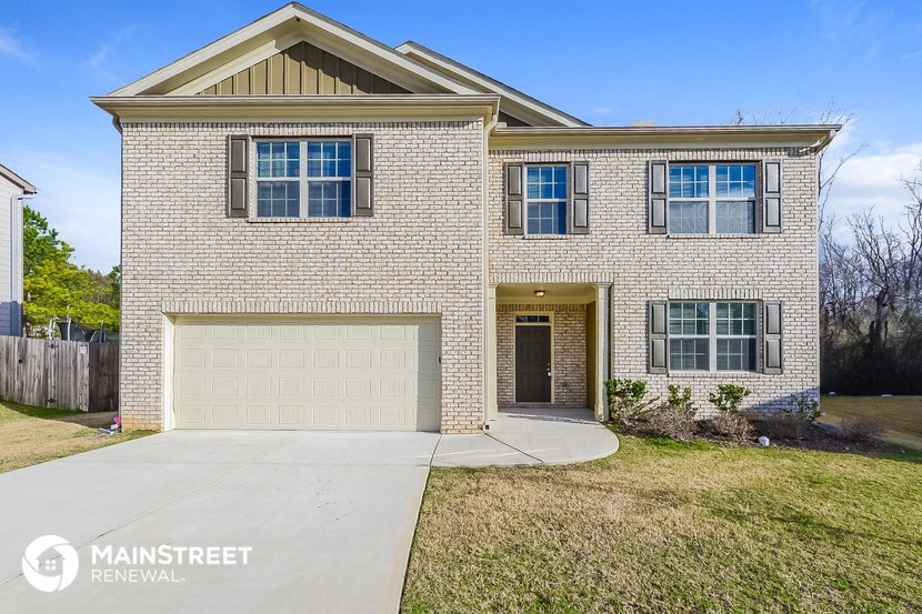 a white brick house with a white garage door