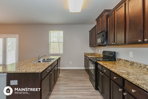 a kitchen with granite counter tops and wooden cabinets