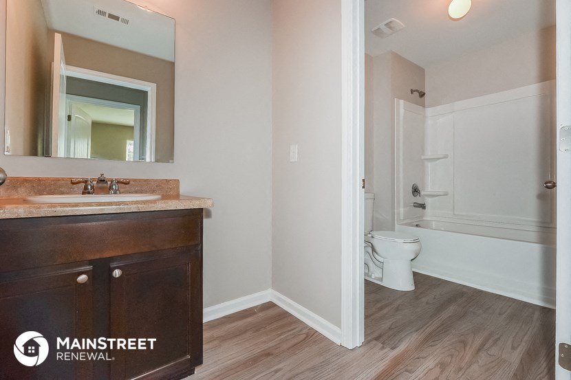 a bathroom with a sink and a toilet and a mirror