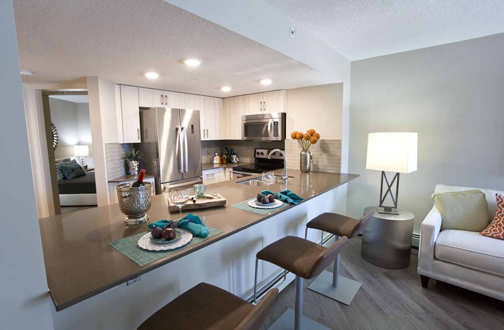 a kitchen with a bar and a living room with a couch