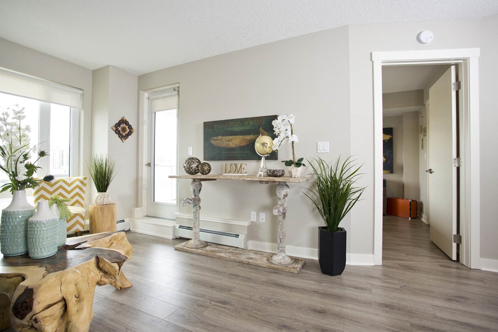a living room with a table and some plants