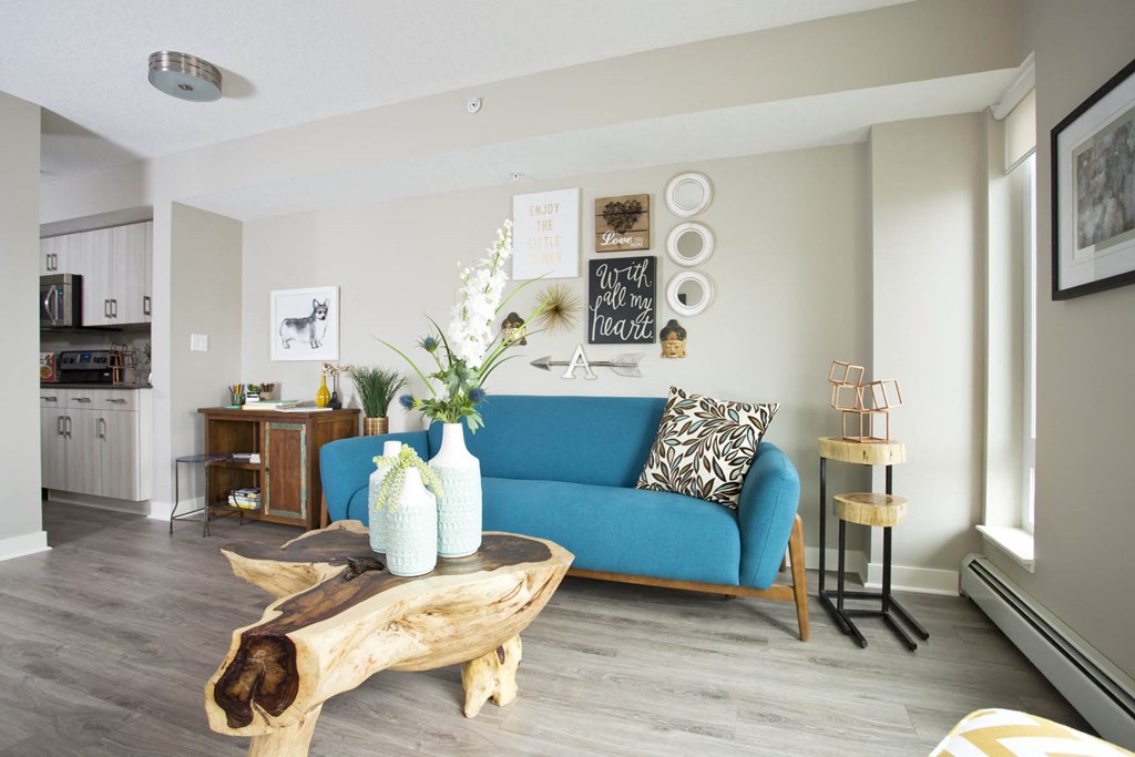 a living room with a blue couch and a table