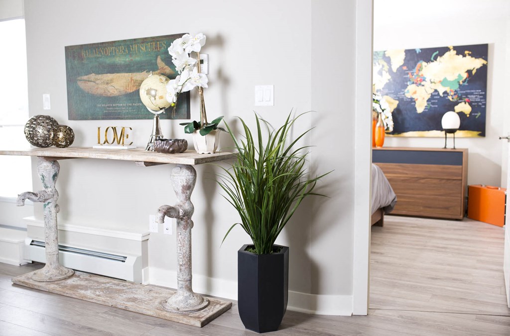 a vase with a plant sitting on a table in a room