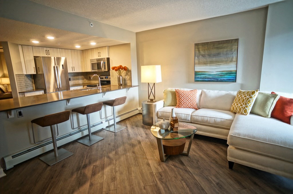 a living room and kitchen with a couch and a table