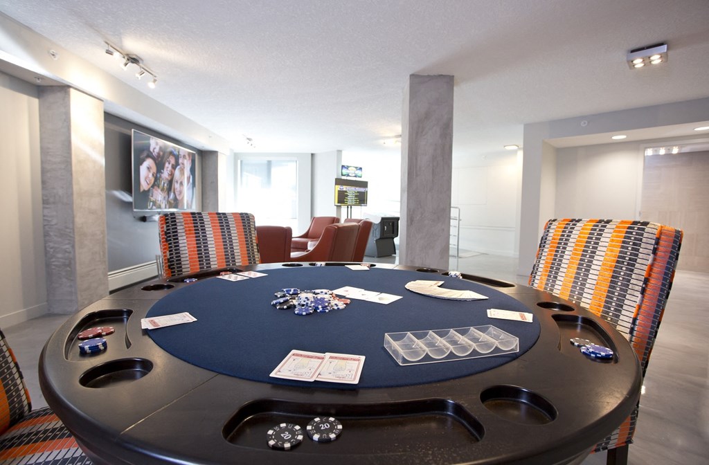 a poker table in a game room with chairs
