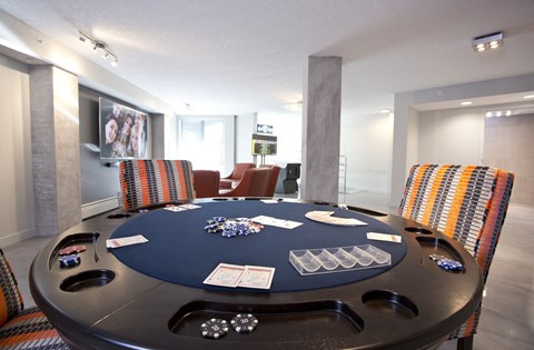 a poker table in a game room with chairs