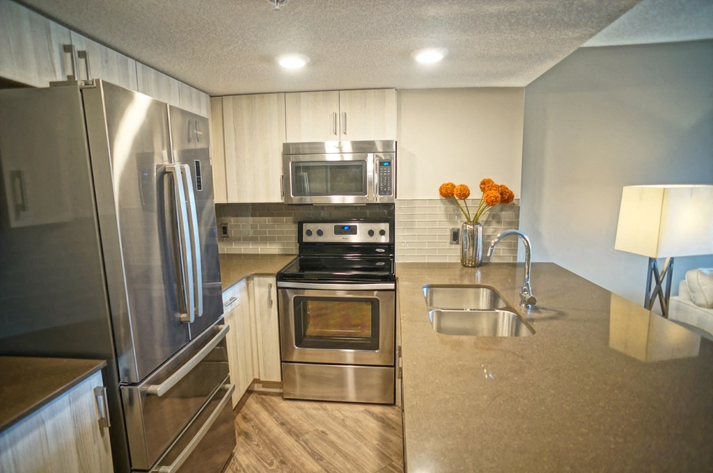 a kitchen with stainless steel appliances and a sink