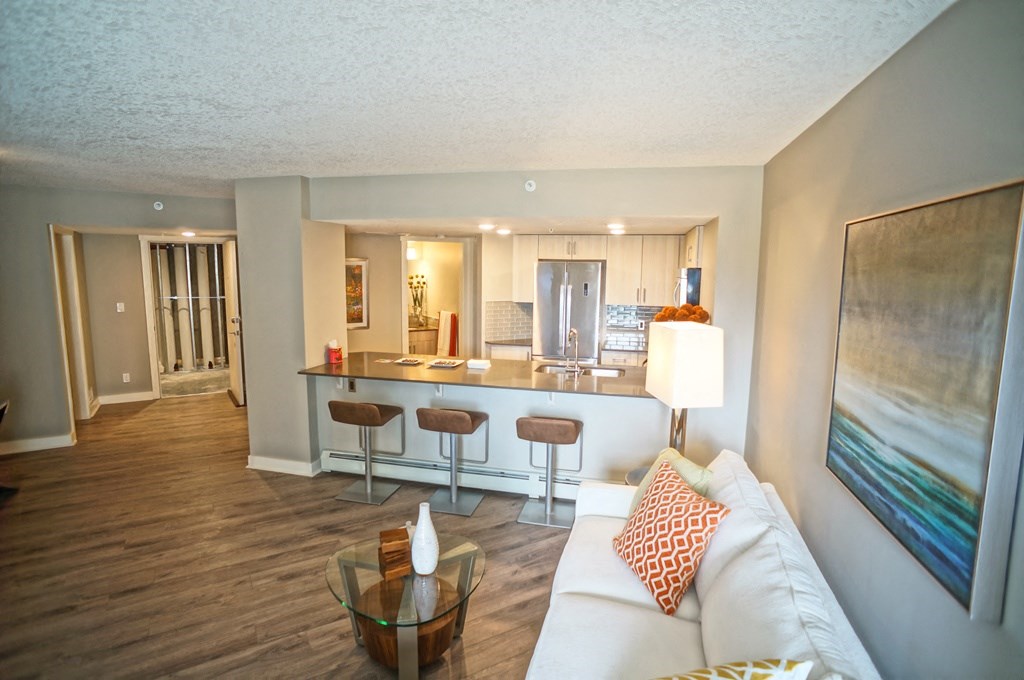 a living room and kitchen with a couch and a table