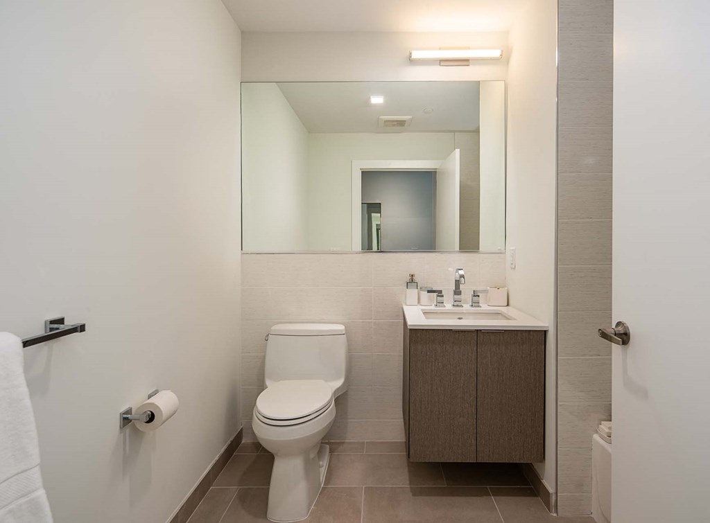 a bathroom with a toilet sink and a mirror