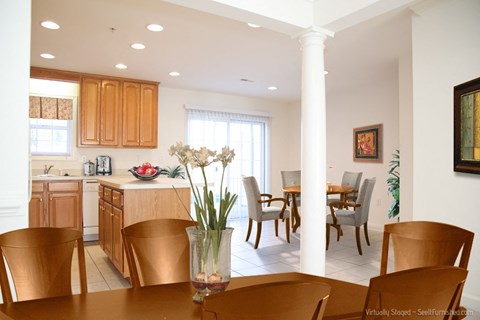 A dining room with a table set for six.