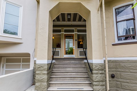 A set of stairs leads to a doorway in a building.