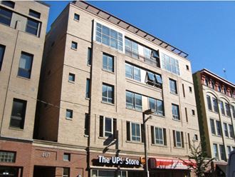 a large brick building with a sign for the up store