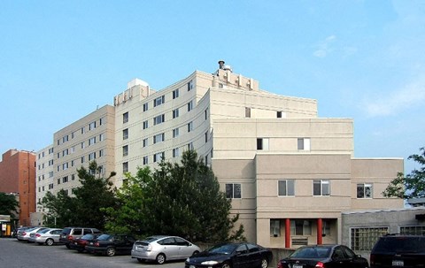 A large building with a parking lot in front of it.