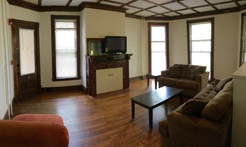 A living room with a brown couch and a black coffee table.