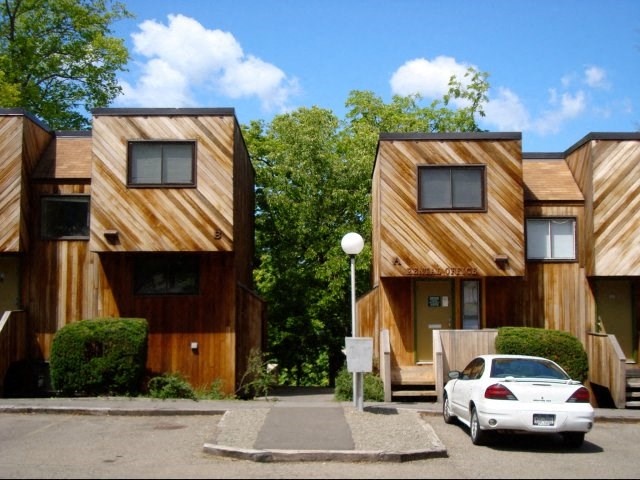 a car parked in front of a row of wooden houses