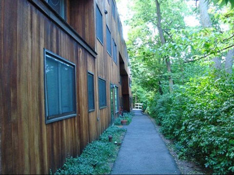 a sidewalk in front of a wooden building