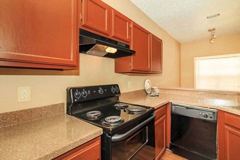 Spacious Kichen with Black Appliances and Custom Cabinetry