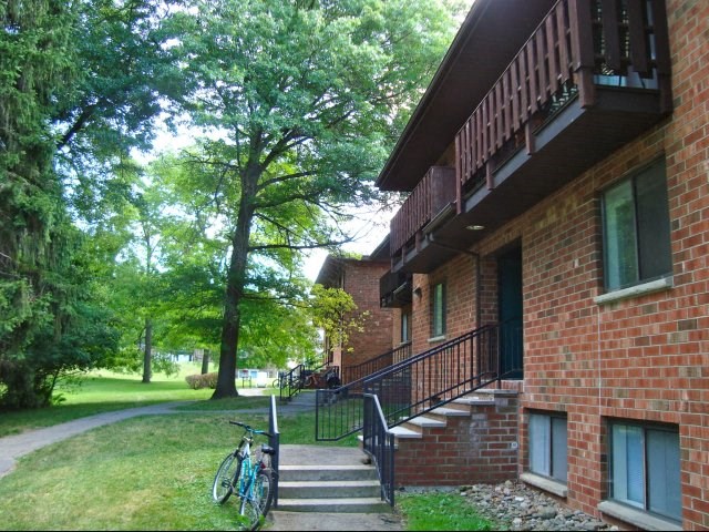 a brick building with stairs and a bike parked outside