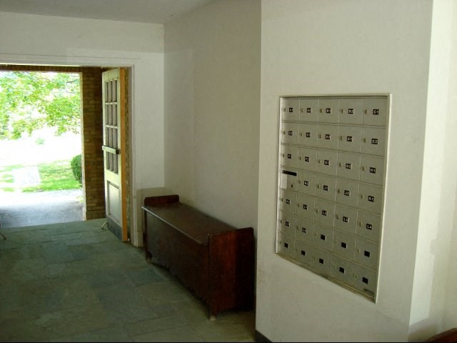 an empty room with a bench and a door