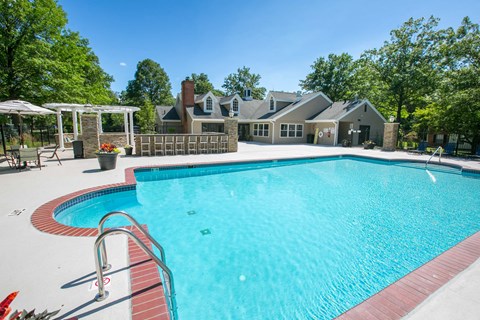 a swimming pool with a house in the background