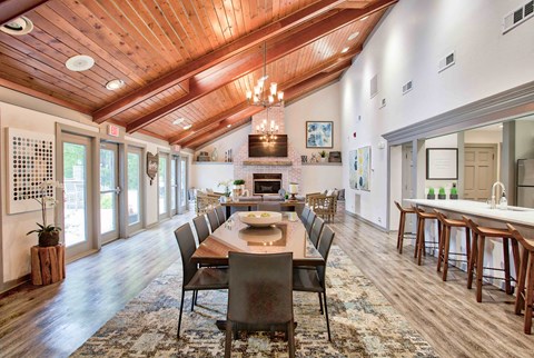 a large dining room with a table and chairs and a fireplace