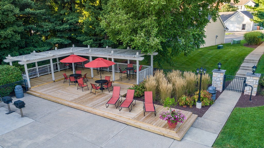 a backyard patio with a pavilion and a seating area with umbrellas