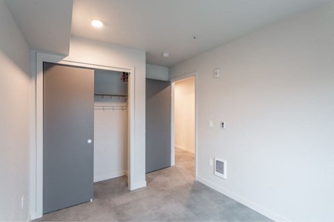 a bedroom with a closet and a door to a laundry room