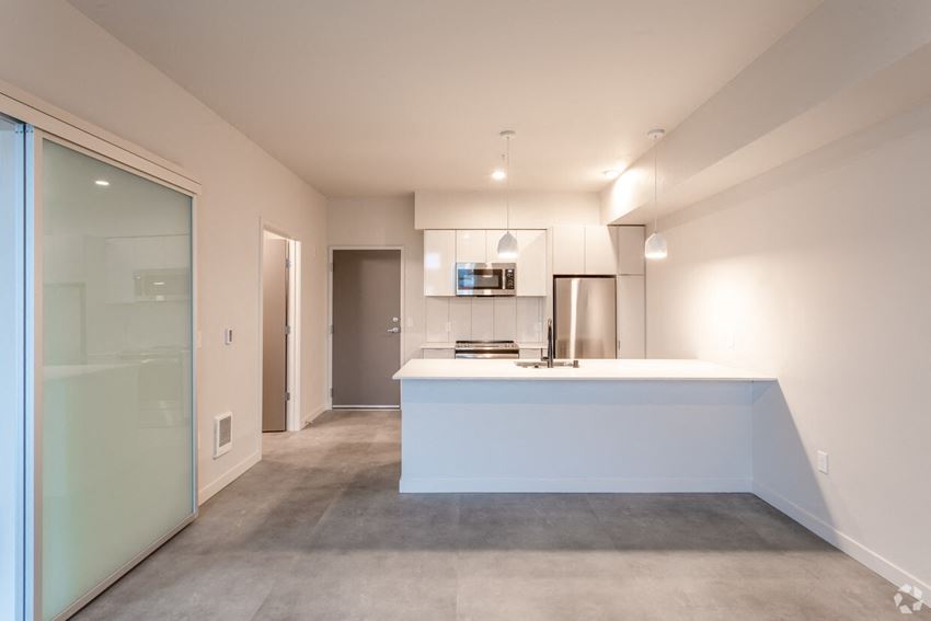a kitchen with a white counter top and a glass door
