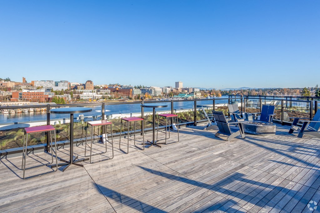 the deck on the top of the building has tables and chairs