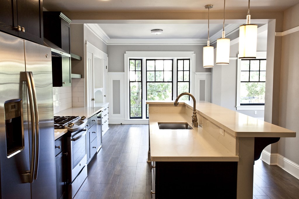 a modern kitchen with a large island and stainless steel appliances