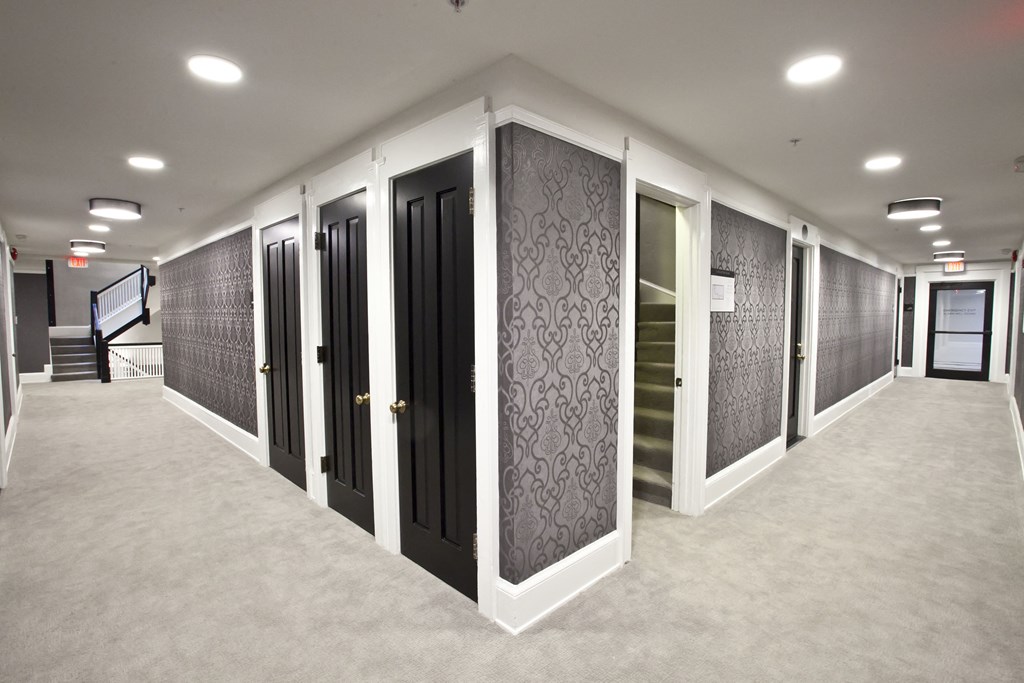 a row of black and white doors in a room